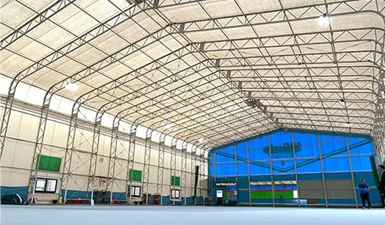 高い天井と明るい光が差し込む鉄骨テント構造の屋内施設